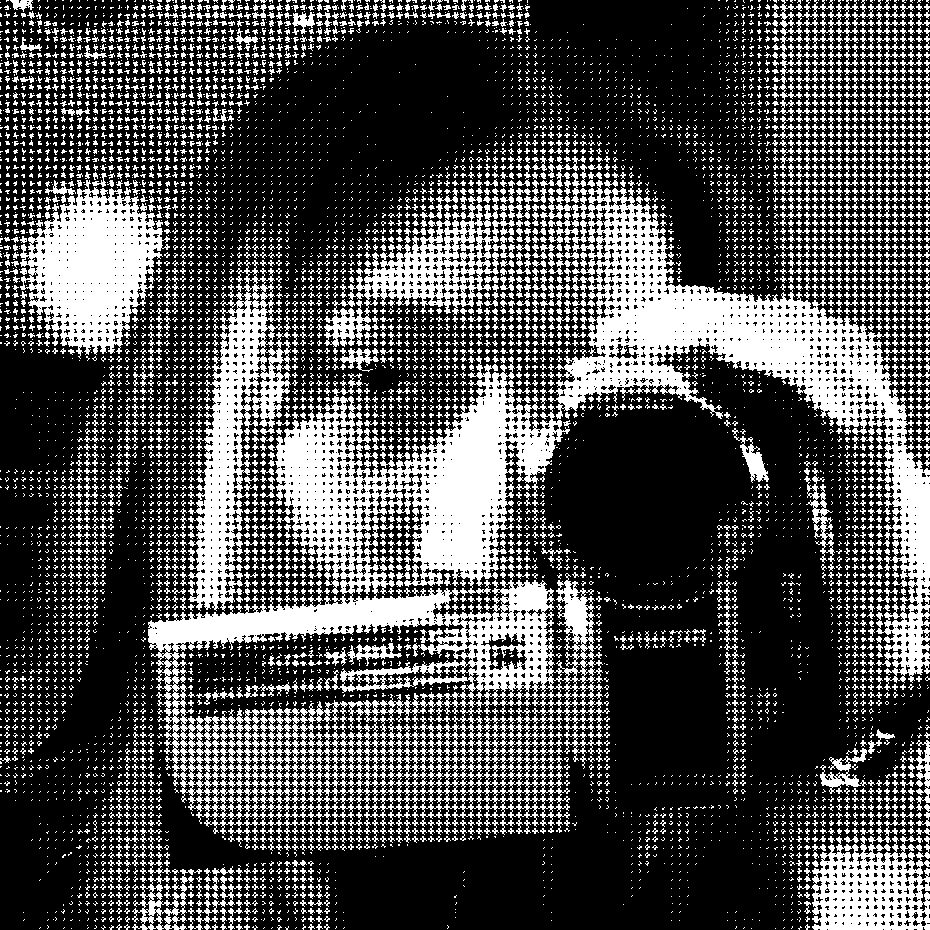 selfie of me holding up my camcorder and covering half my face with it as i look into the view finder. the image is black and white, dithered, and covered in spotted half tones